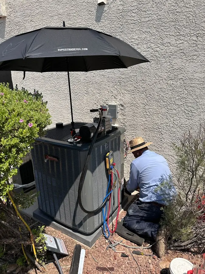 HVAC technician performing outdoor AC maintenance in Buckley